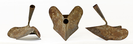 three views of an old rusty iron hand ploughの写真素材
