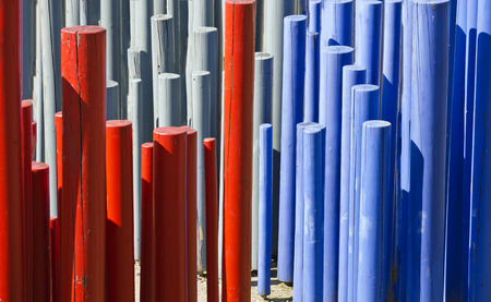 red, gray and blue painted wooden rodsの写真素材