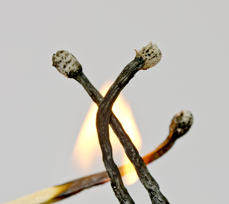 Near view of three black burnt down matches