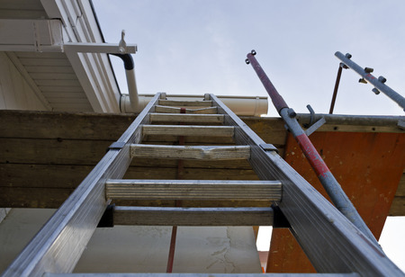 old metallic ladder as ascent to a scaffoldの写真素材