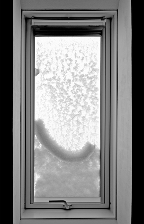 inside view of a snow covered white roof-top windowの写真素材