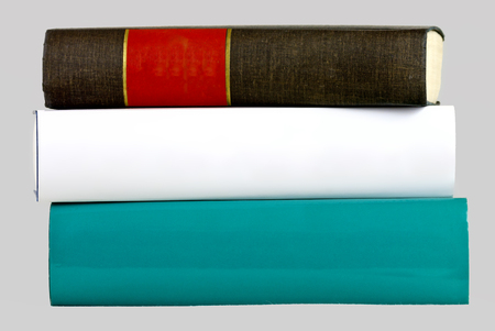 isolated stack of three thick books, green, white and blackの写真素材
