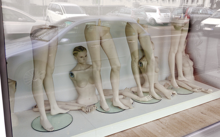 Shopping window with parts of undressed fashion dolls during re-decorationの写真素材