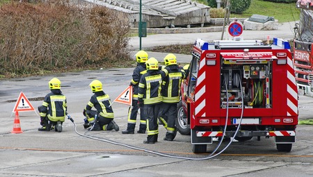 fire fighters with fire truck at a training