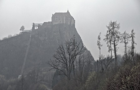 view to the castle Riegersburg on a steep rock at foggy weather, Styria, Austriaのeditorial素材