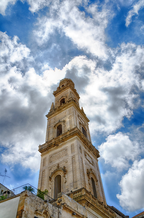 blue sky with glowing clouds and the tower of the cathedral of Lecce, Italyのeditorial素材