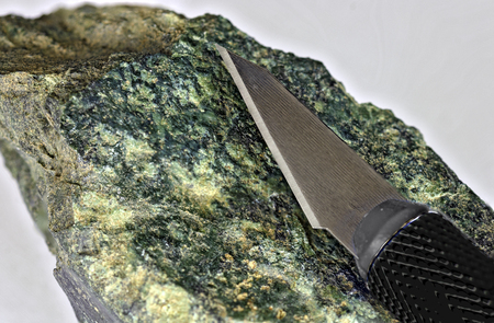 exchangeable blade of a precision knife made from stainless steel on a granite stone
