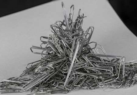 heap of big and small metallic paperclipsの写真素材