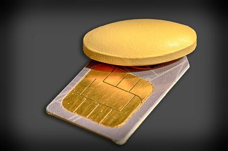 medicin pill lying on top of a chip cardの写真素材