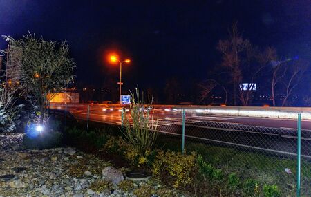 illuminated decorative garden beside a freeway at night, Austria