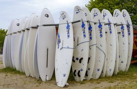 storing place with upright standing surfboards at the Baltic seaの写真素材