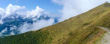 hiking path along the slope of the mountain Helm (Monte Helmo) at Alto Aldige with view to the Sextner dolomites, Italyの写真素材