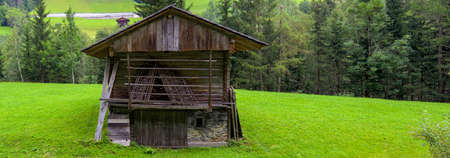 old traditional hay barn on a meadow in the Lesach Valley near Maria Luggau in Carinthia, Austriaの写真素材