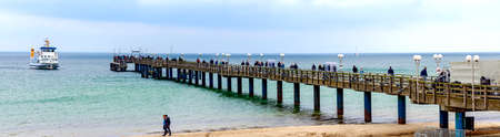 Panoramic view of the pier with incoming pleasure ship in the bath and spa village of Binz at the Baltic sea on RÃ¼gen, Germanyの写真素材
