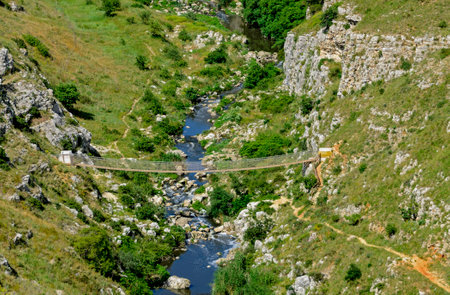 suspension bridge in the ravine Gravina di Matera, Italyの写真素材