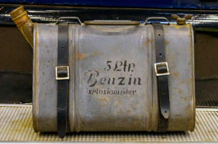 old reserve fuel tank of a classic car with leather beltsの写真素材