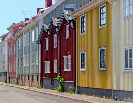 colorful wooden facades of houses in a street in the little town of Vaestervik, Swedenの写真素材