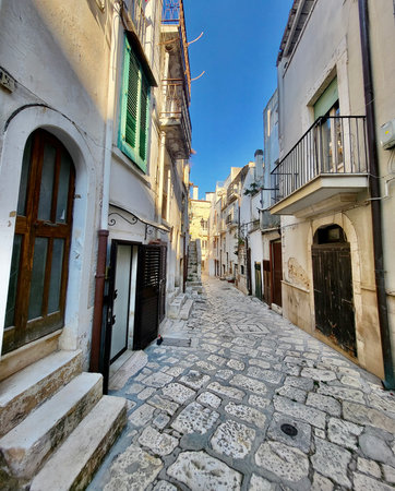 Quaint, narrow cobblestone street in Puglia. Italy.