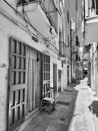 Black and White Narrow cobblestone street in Southern Italy. Puglia. Italy.の写真素材