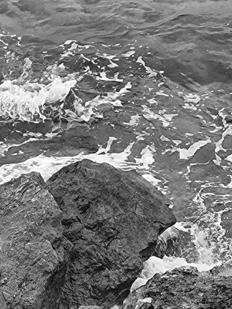Black and white photo of ocean waves crashing on coastal rocks in Puglia, Southern Italy â dramatic Mediterranean seascape with rocky shorelineの写真素材