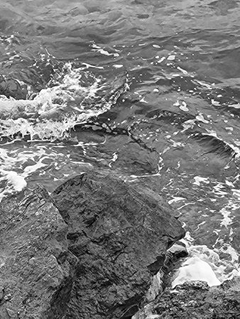 Black and white photo of ocean waves crashing on coastal rocks in Puglia, Southern Italy â dramatic Mediterranean seascape with rocky shorelineの写真素材