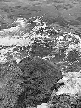 Black and white photo of ocean waves crashing on coastal rocks in Puglia, Southern Italy â dramatic Mediterranean seascape with rocky shorelineの写真素材