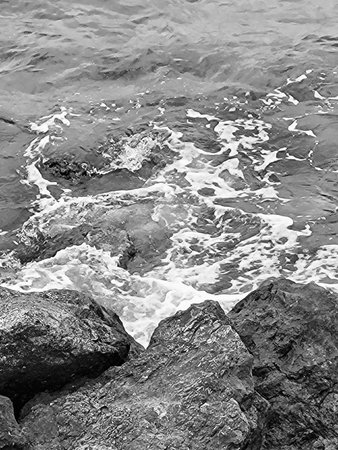 Black and white photo of ocean waves crashing on coastal rocks in Puglia, Southern Italy â dramatic Mediterranean seascape with rocky shorelineの写真素材