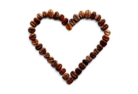 Heart of the coffee grains on white backgroundの写真素材