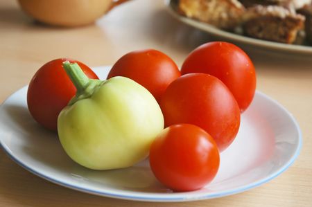 Tomatoes and peppers on a plateの写真素材