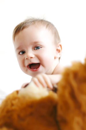 Little boy playing with a bearの写真素材