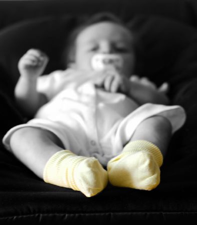 Detail of children's feet with yellow socksの写真素材