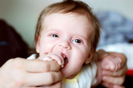 A baby sucking her fingers .の写真素材