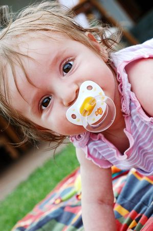 A little girl with a pacifier .の写真素材