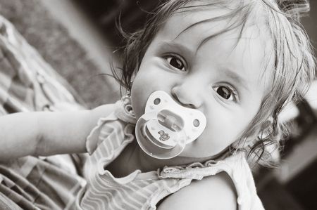 A little girl with a pacifier .の写真素材