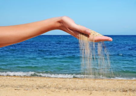 Sand falling from the woman's hand