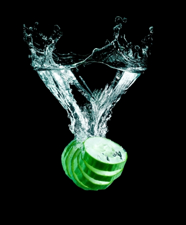 The cucumber slices falling into water .の写真素材