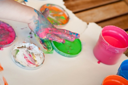 Little girl painting colors on handの写真素材