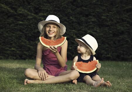 The little girl and boy and the watermelon .の写真素材