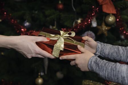 The mother gives her daughter a Christmas presentの写真素材