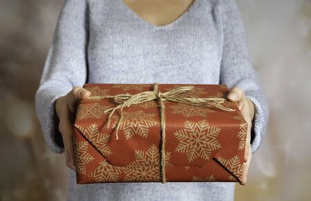 The woman giving a present with ribbonの写真素材