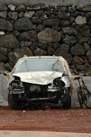 Car wreck near a stone wall in the Azores islandsの写真素材