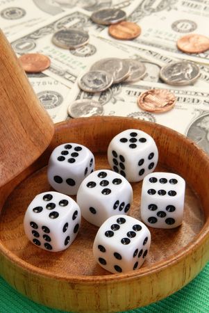 Five dice with a wood dice cup