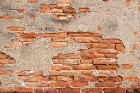 An ancient motley red brick wallの写真素材