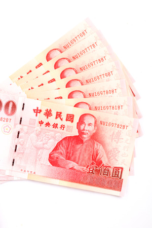 A lot of 100 New Taiwan Dollar bill on white backgroundの写真素材