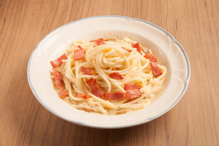 Spaghetti with bacon and cream sauce on plate.の写真素材