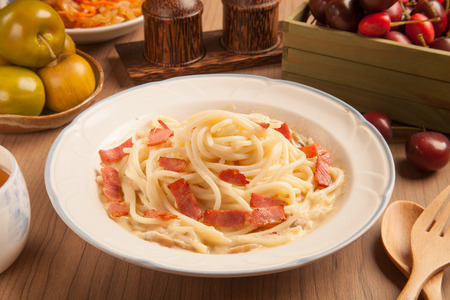 Spaghetti with bacon and cream sauce on plate.の写真素材