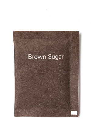 Brown sugar packet on white backgroundの写真素材