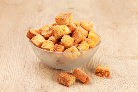 Delicious fried croutons in glass bowl