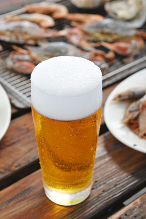 A glass of beer on the tableの写真素材