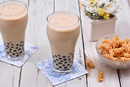 Milk tea with pearls on wooden table.の写真素材